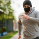 Man running in a black sporty mask